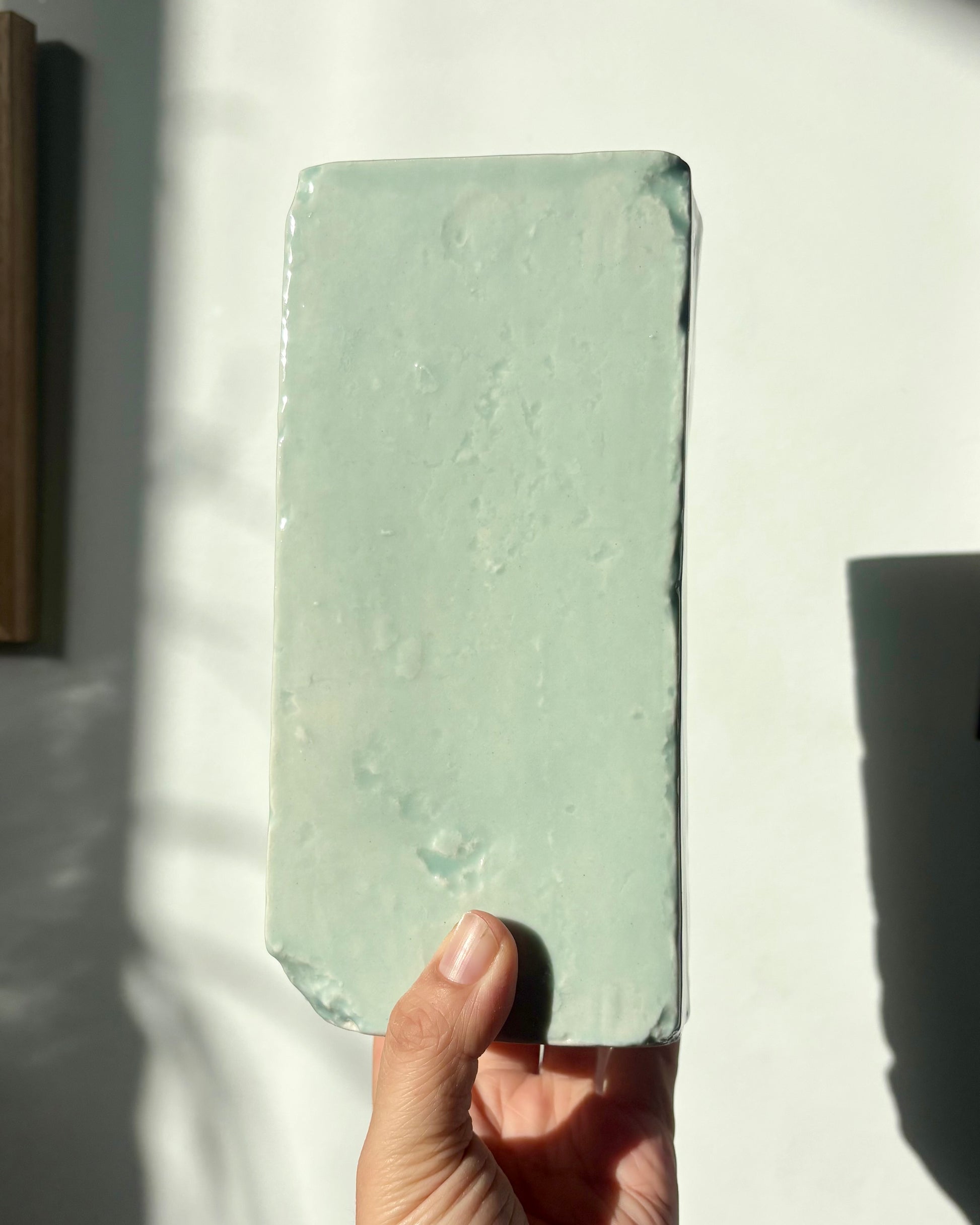 Hand holding Pale Jade Ceramic Brick Vase Back